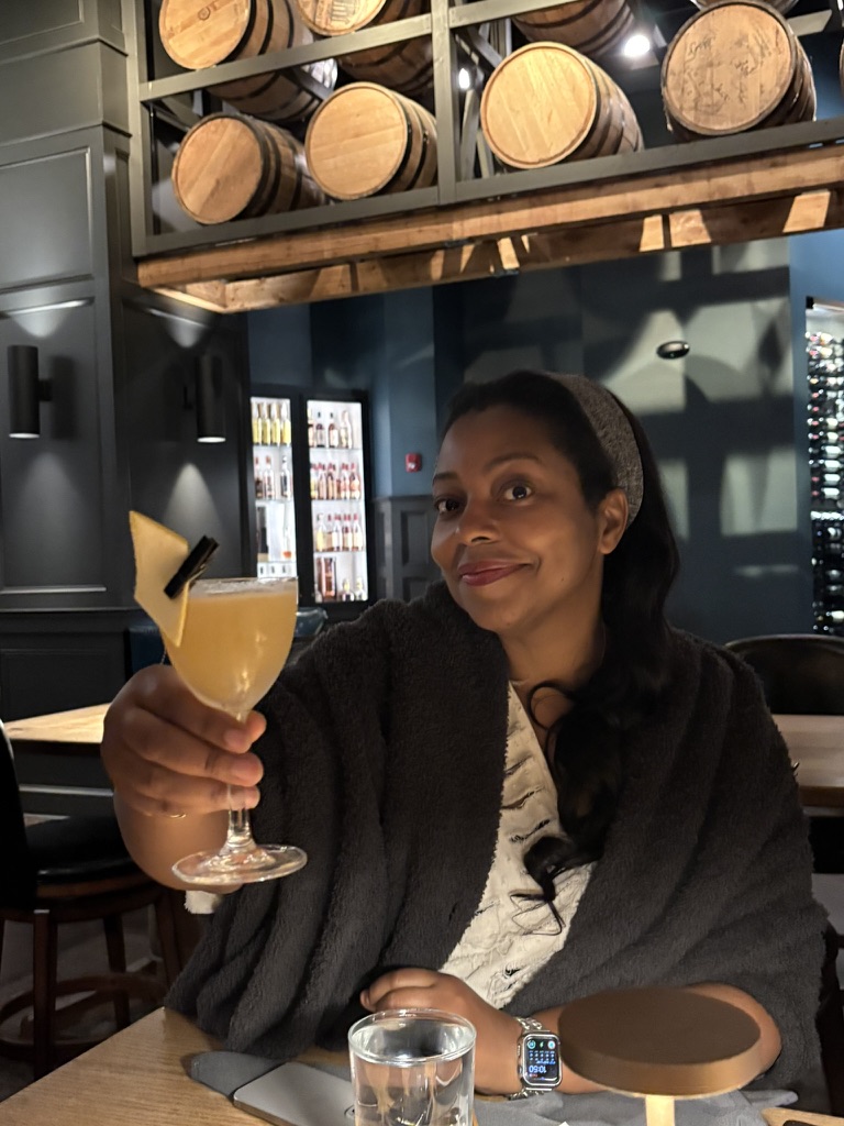 Kim Knight Henderson raising a cocktail