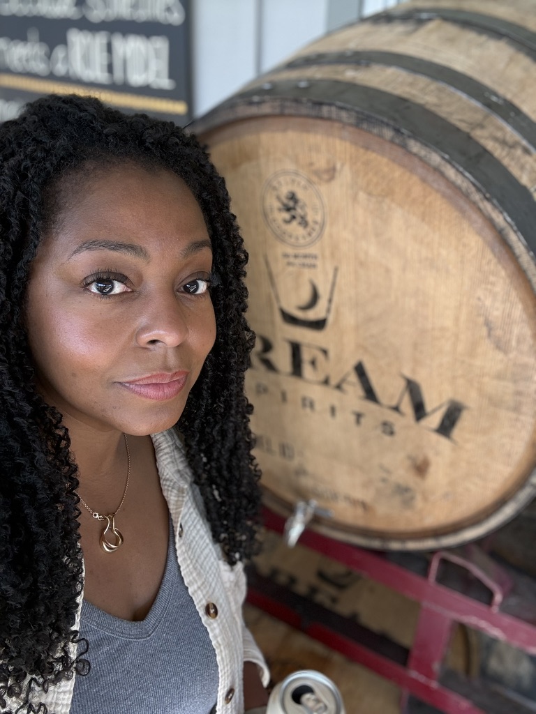 Kim beside a Dream Spirits barrel